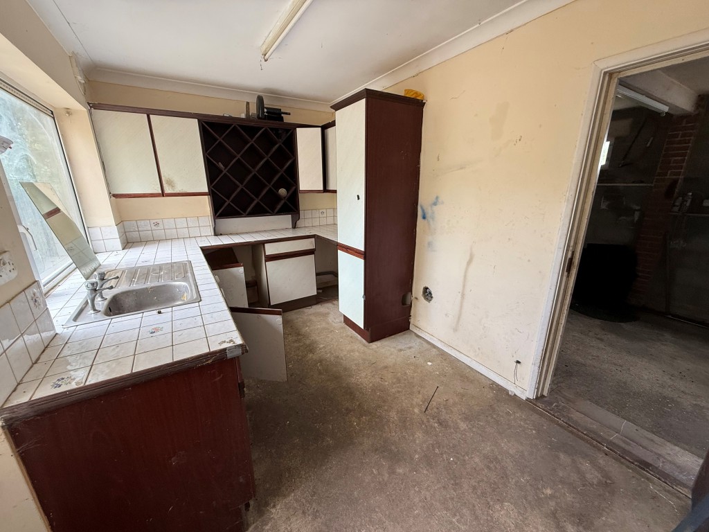 Lot: 136 - FOUR-BEDROOM DETACHED HOUSE FOR REPAIR AND MODERNISATION - utility room with built in cupboards and door to garage